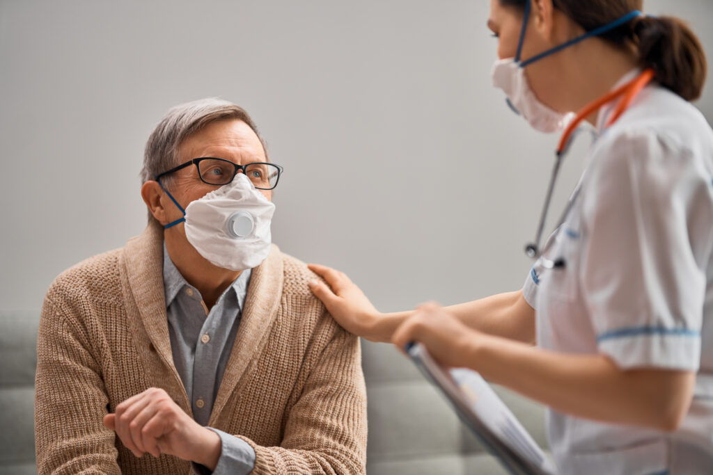 A covid patient wearing a mask with a doctor